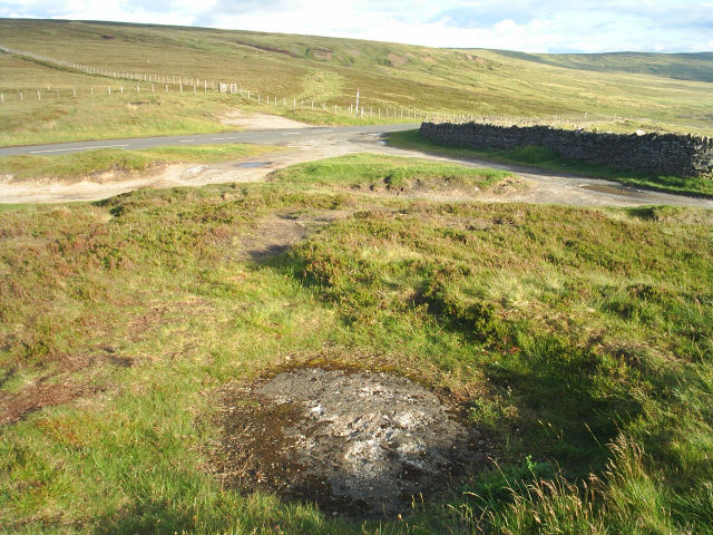The road from Carrshield to Nenthead where it borders Northumberland and Cumbria. In the foreground is a sealed mineshaft.